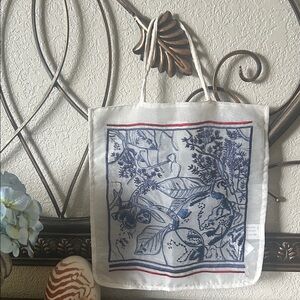 This is a Zara tote bag. It feature blue floral embroidery on the front and back